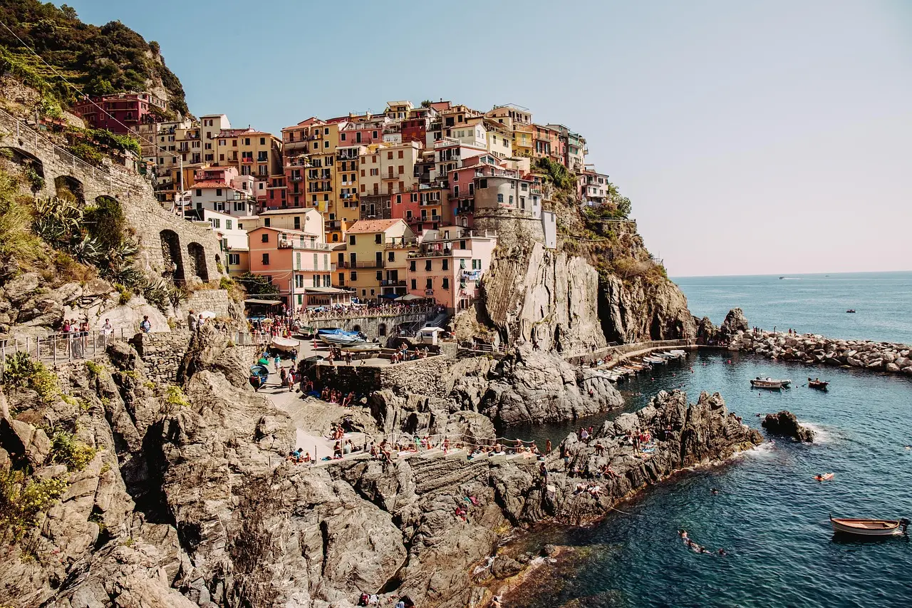 Casas coloridas de Manarola refletidas no mar ao entardecer